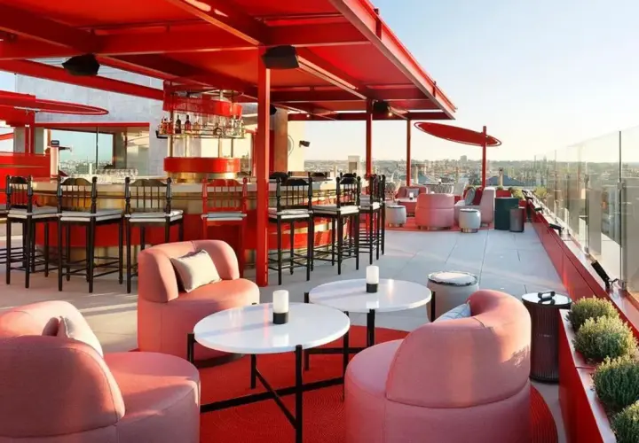 Modernas terrazas azoteas Madrid baratas con mobiliario rosa y barra roja, vistas a la ciudad.
