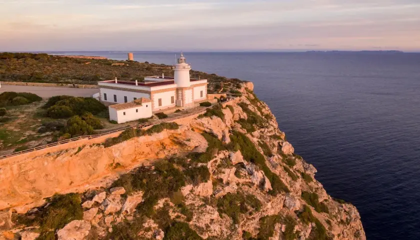 El mirador Sa Foradada, con su faro blanco y el mar azul al atardecer, ofrece vistas espectaculares.
