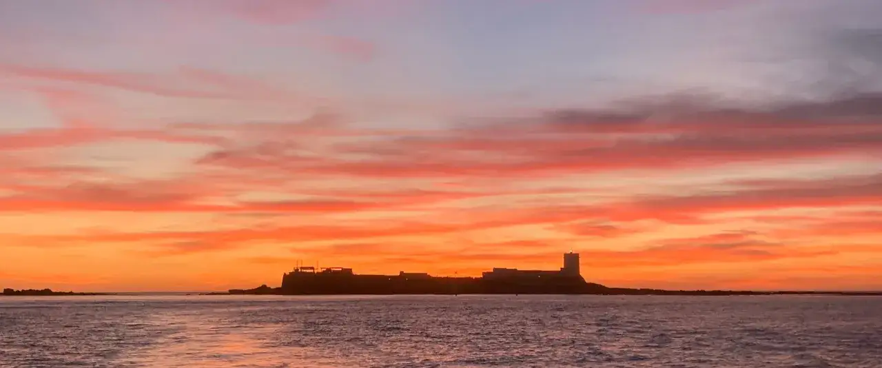 Atardecer espectacular en Sancti Petri. El castillo se recorta contra un cielo de fuego, un paseo mar&iacute;timo de ensue&ntilde;o.